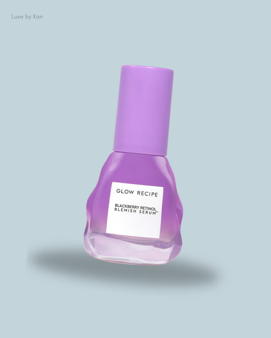 A glass bottle of Glow Recipe Blackberry Retinol Blemish Serum with a purple cap.