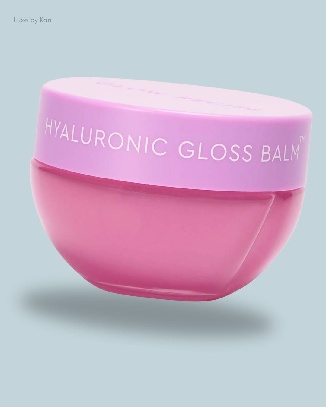 A pink pot of Glow Recipe Plum Plump Hyaluronic Gloss Balm with a lavender lid, labeled "Hyaluronic Gloss Balm."