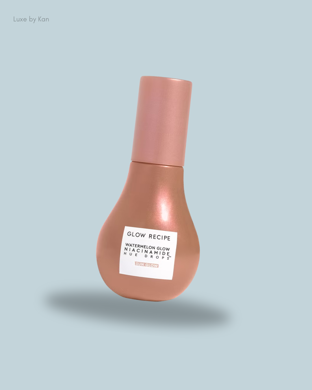 A rose gold bottle of Glow Recipe Watermelon Glow Niacinamide Hue Drops, highlighting its sleek design.