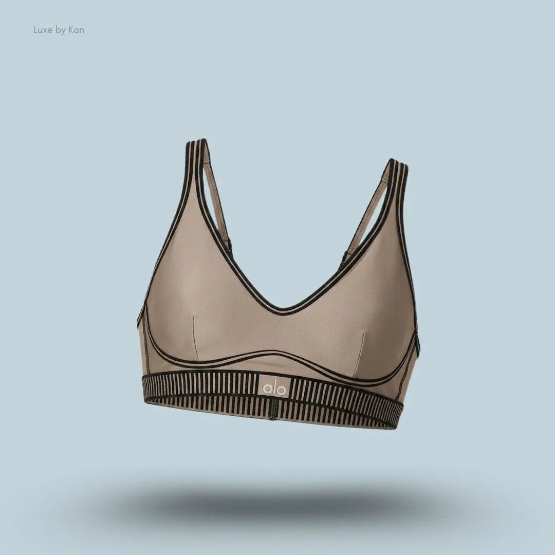 Alo Airlift Line Up Bra in Gravel, flat lay on light blue background
