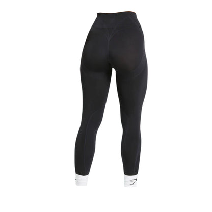 Black leggings with high waist, featuring subtle seam details and fitted design, shown from the back.