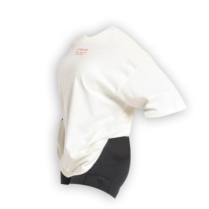 A side view of a British Iron Heavyweight white T-shirt with short sleeves and a small red logo, paired with black shorts.