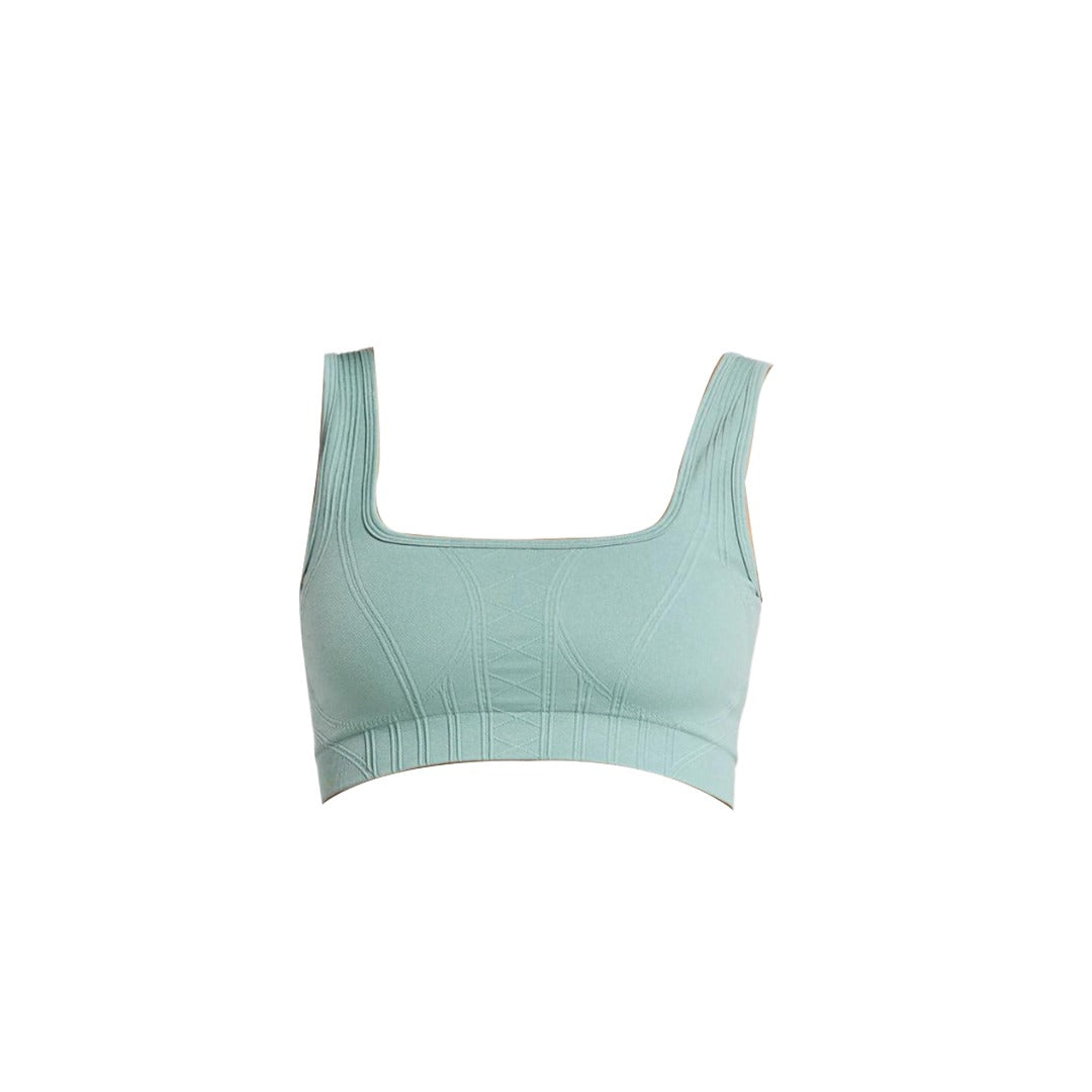 A mint green athletic crop top with a square neckline and textured detailing, designed for comfort and support.