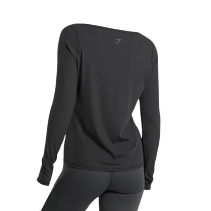 A stylish black Gymshark Elevate Long Sleeve Top, viewed from the back and paired with matching leggings.
