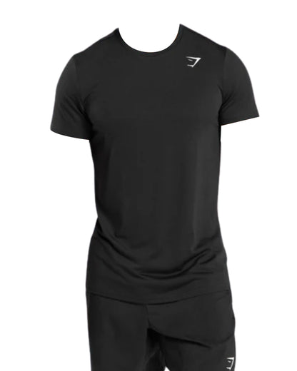 A black short-sleeve Gymshark Men’s Arrival athletic T-shirt with a subtle front logo, shown without a model. Ideal for workouts or casual wear.