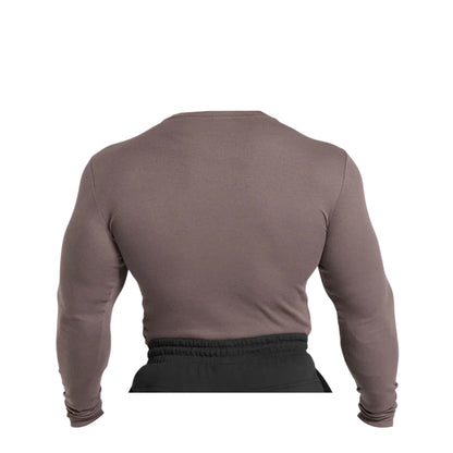 Close-up of a Gymshark men's brown, ribbed long-sleeve t-shirt on a torso form.