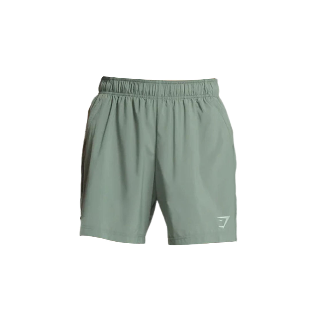 Gymshark men sport 7" everyday shorts, slim fit, in a light sage color, featuring the brand logo on the bottom left.