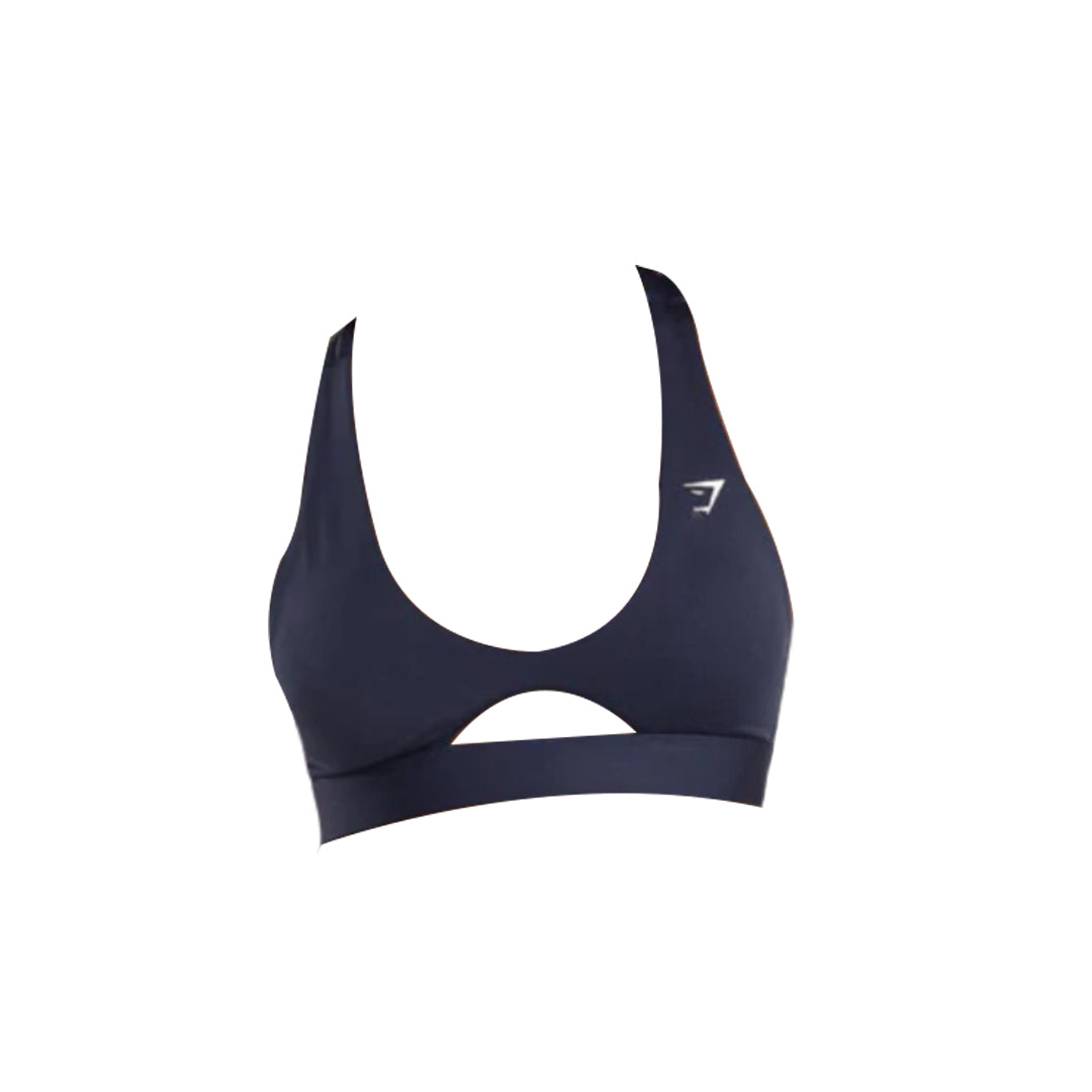 Navy blue Gymshark sports bra with a rounded peek-a-boo cut out, and the Gymshark logo, isolated on a white background.