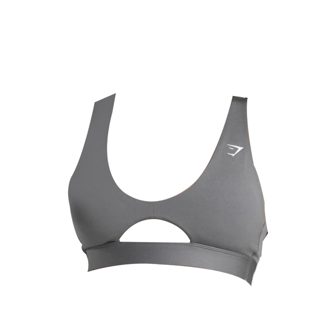 Close-up of a gray Gymshark sports bra featuring a high neckline and a keyhole cutout just above the band, with the Gymshark logo visible on the left side.