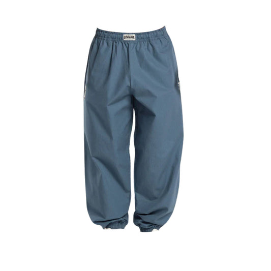 Light blue oversized-fit pumper pants with an elastic waistband and cuffs, featuring side zipper pockets.