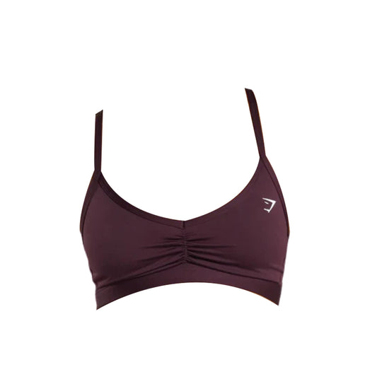 Hot pink sports bra with adjustable straps and gathered detailing at the front, featuring a small white logo on the side.