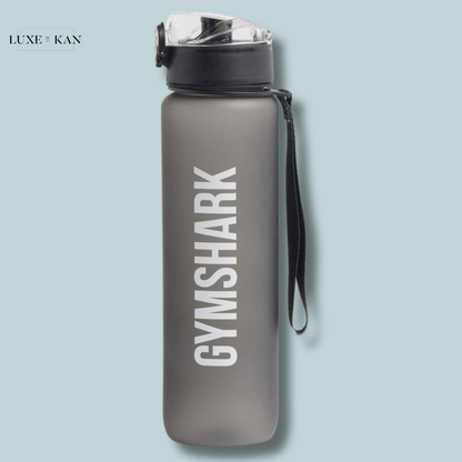 A grey Gymshark sports bottle with a transparent cap and strap, featuring the brand name in white against a blue background.