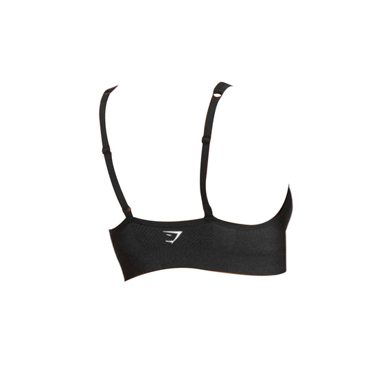 A black Gymshark Vital Seamless V Neck Sports Bra, showcasing the rear view with adjustable straps and the Gymshark logo.