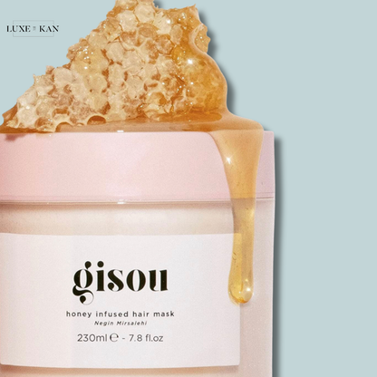 Gisou honey-infused hair mask with honeycomb and drizzling honey on top.
