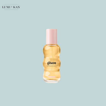 Gisou honey-infused hair perfume with a soft pink cap,