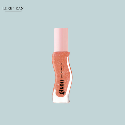 Gisou Honey Infused Lip Oil sparkling pink lip gloss in a wavy clear tube with a pink cap.