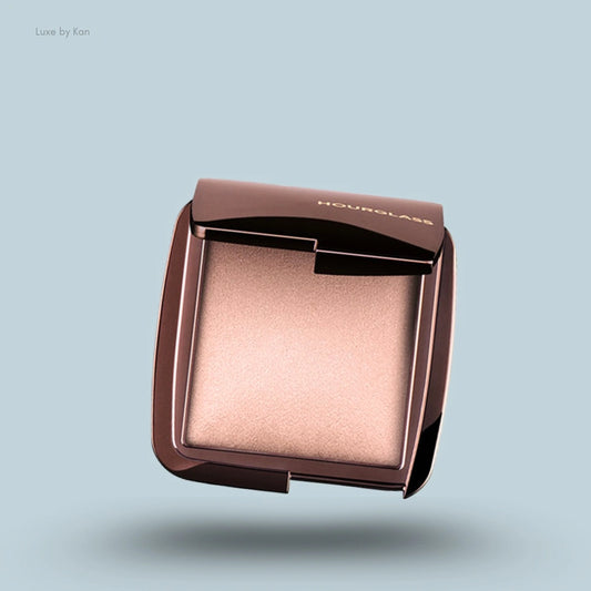 Hourglass Ambient™ Lighting Finishing Powder in a compact with a reflective bronze case.
