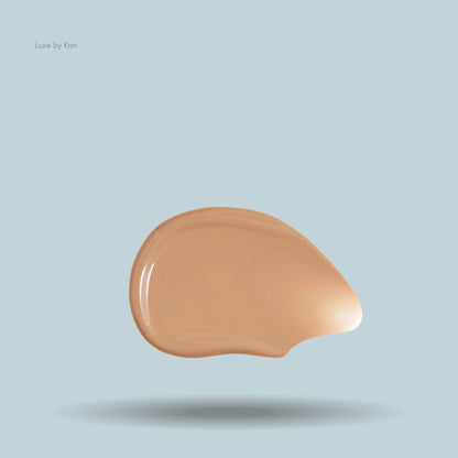 A swatch of hydrating skin tint featuring a droplet-shaped blot of tan fluid atop a light blue backdrop.