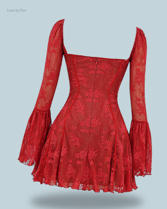 House of CB red Analissa lace corset dress with long, flared sleeves, a structured bodice, intricate floral detailing, and a voluminous flared skirt.