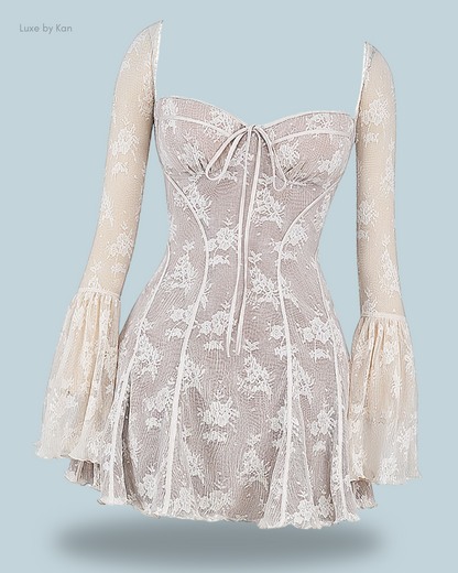 A light-colored floral House of CB Analissa lace corset dress featuring a strapless bodice, delicate drawstring detail, and long bell sleeves.