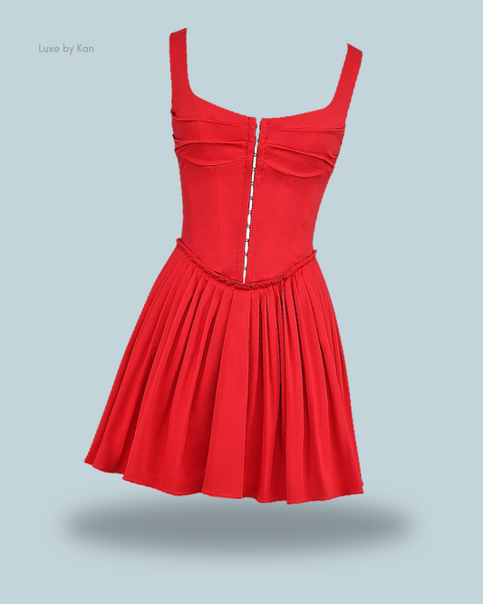 Front view of House of CB Cupid pleated mini dress in red, featuring wide straps, boned corset, and a flowy hem.