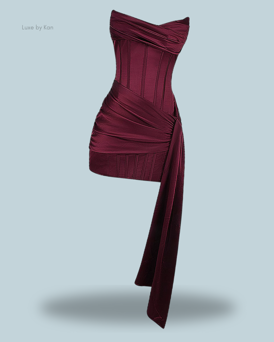 Burgundy loubella mulberry strapless corset dress with structured bodice and draped fabric detail, showcasing a blend of elegance and sophistication.