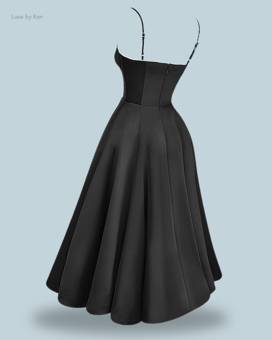 A stylish black mademoiselle tulle midi dress with a fitted bodice and flared skirt, featuring adjustable spaghetti straps.