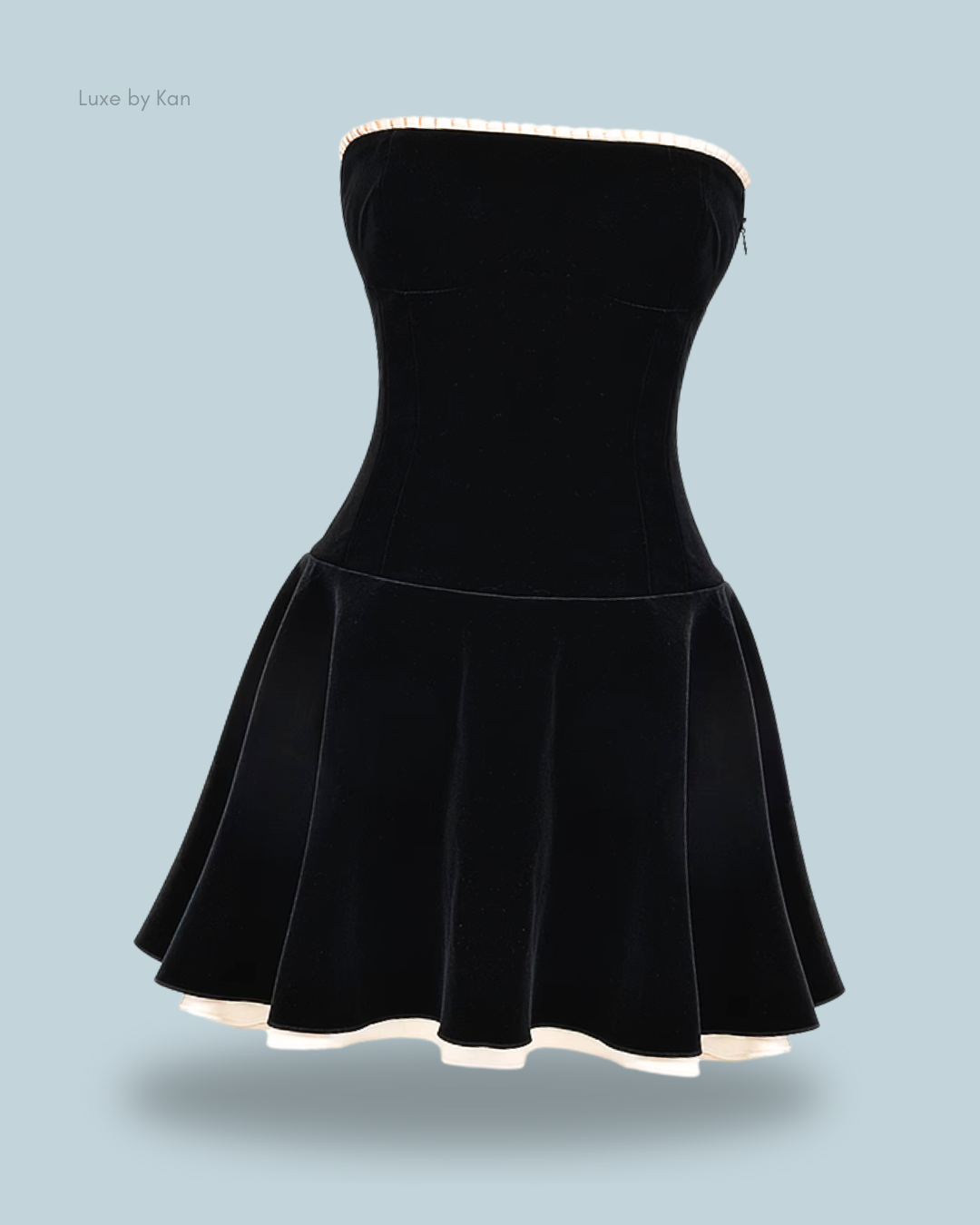 A strapless marilla black velvet strapless dress with a flared skirt and a contrasting light-colored hem.