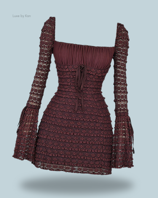 A rich burgundy marisa espresso lace dress with a fitted bodice, square neckline, and intricate puff sleeves, featuring delicate lace and tiered ruffles.