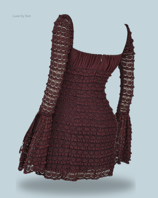 A burgundy marisa espresso lace dress with long, flared sleeves and a fitted silhouette, featuring intricate textured detailing and a square neckline.