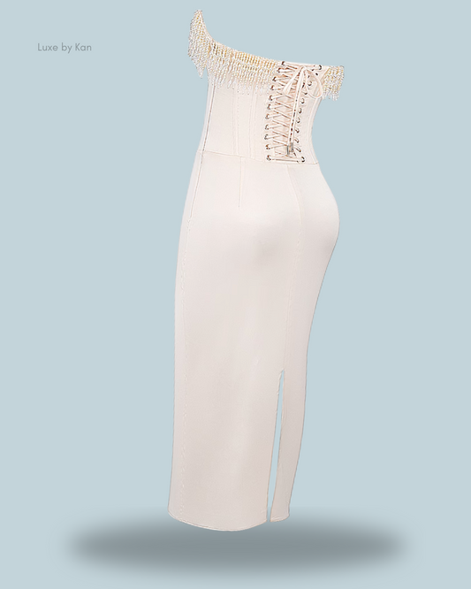 A chic off-shoulder House of CB Nalita vintage cream strapless dress featuring pearl embellishments, lace-up detailing, and a modest slit at the hem.