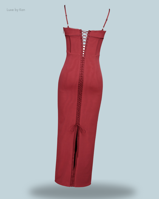 A form-fitting Romy mesh maroon bodycon maxi dress featuring thin straps, a sleek silhouette, a lace-up back, and a subtle slit detail for added allure.