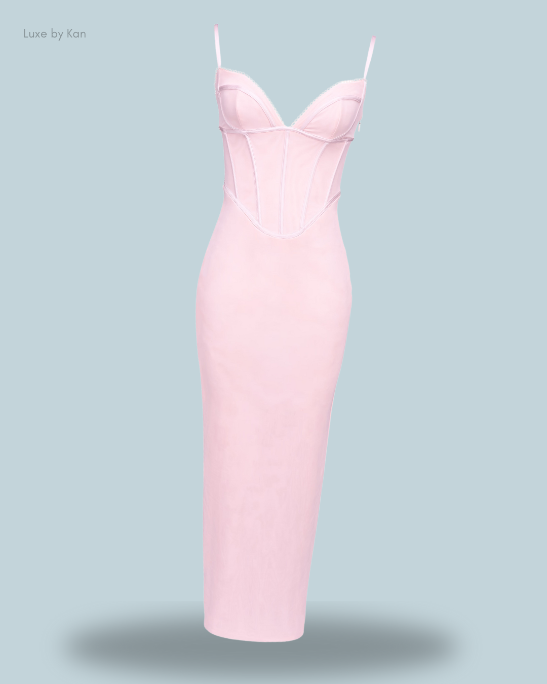 A fitted, light pink dress with a structured bodice and adjustable straps, showcasing a chic and elegant design.