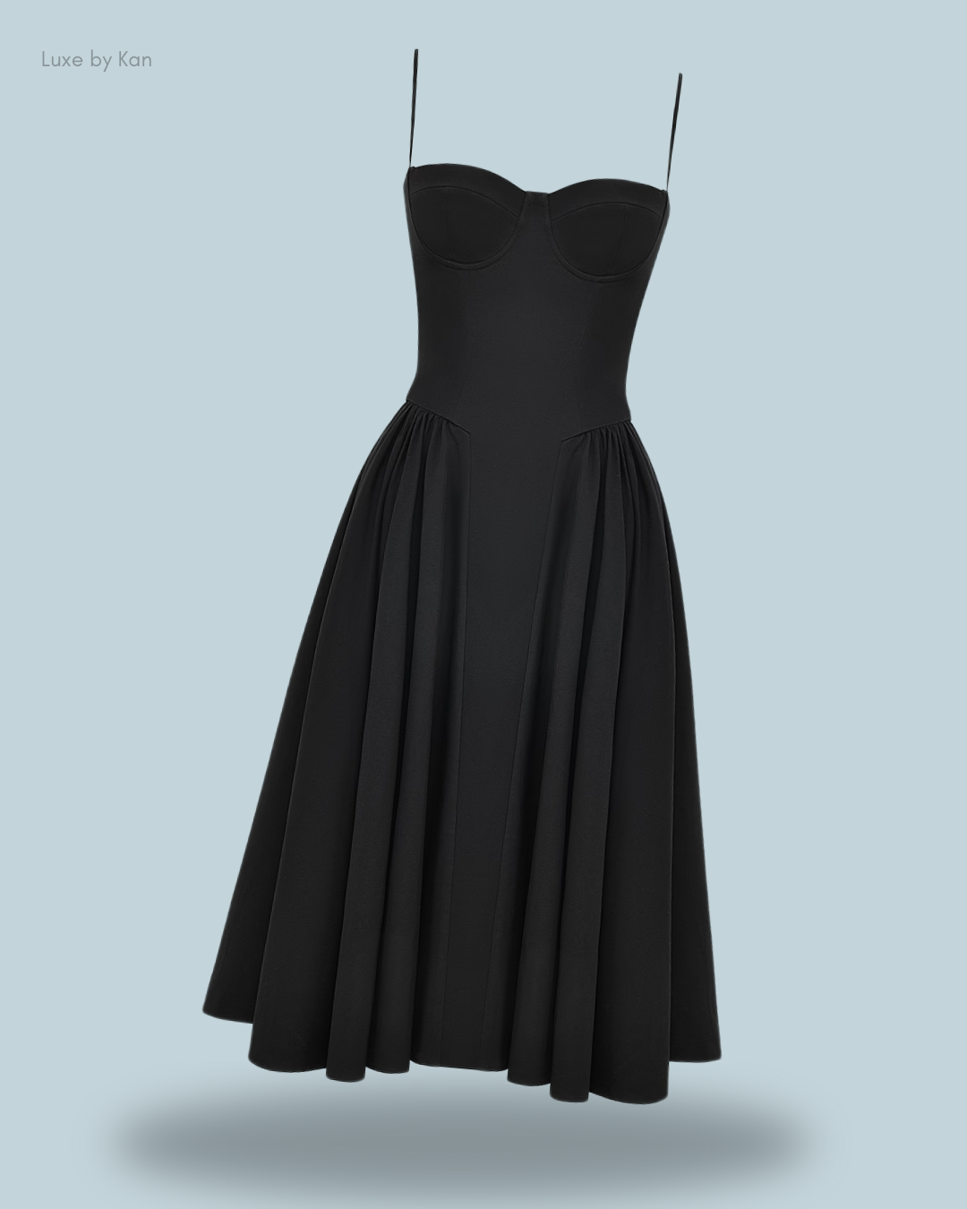 A chic black House of CB strapless dress featuring a sculpted bodice and a flowing pleated skirt, blending elegance with modern sophistication.