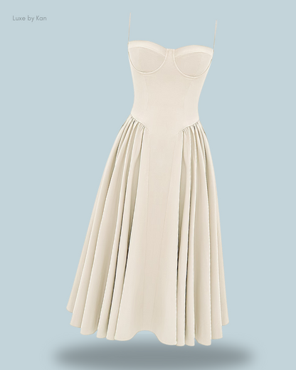 A stylish off-white A-line dress with a structured bodice and pleated skirt, set against a soft blue background.