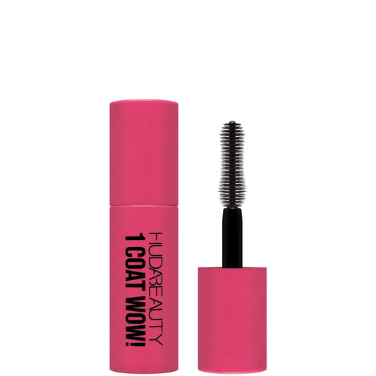 A bright pink mascara tube labeled "Huda beauty 1 Coat Wow!" with a black brush partially visible, emphasizing bold, voluminous lashes.