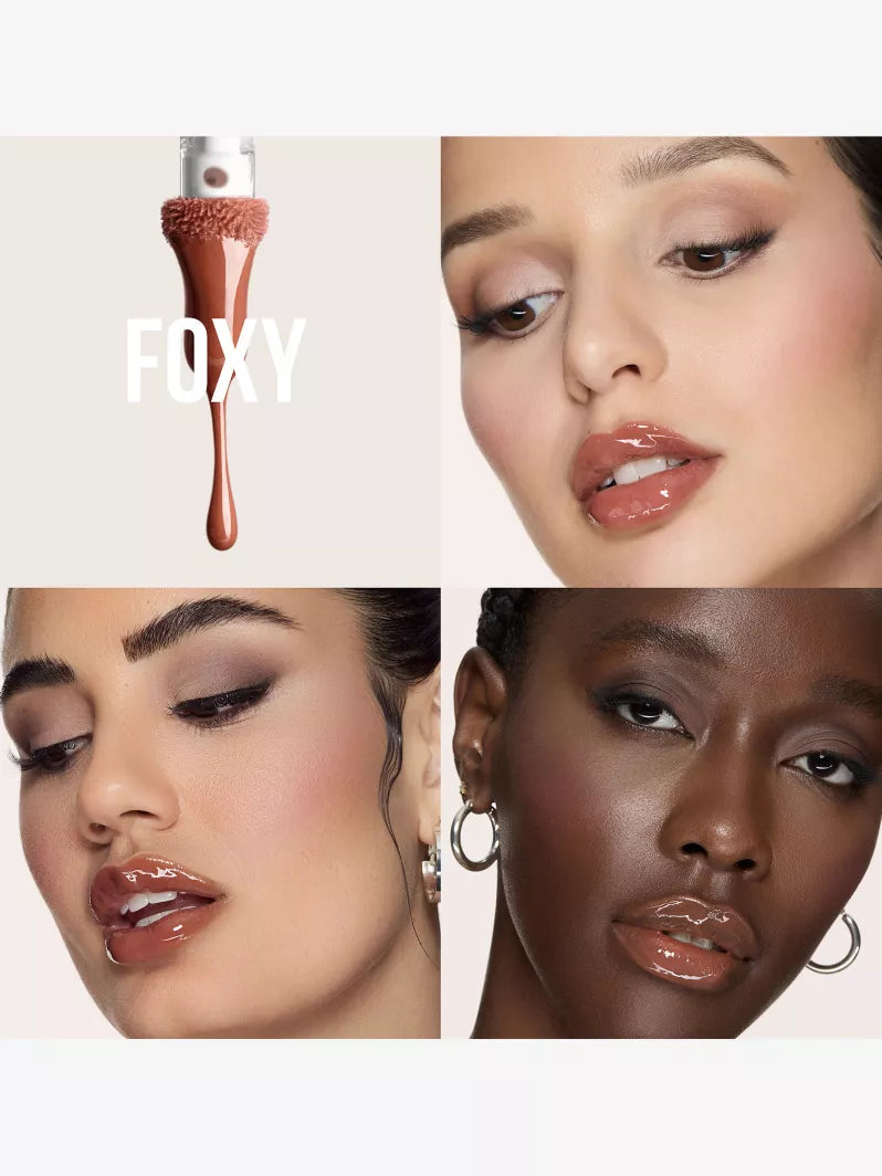 A makeup product labeled "FOXY" drips from a stylish applicator, showcasing a rich, warm shade.
