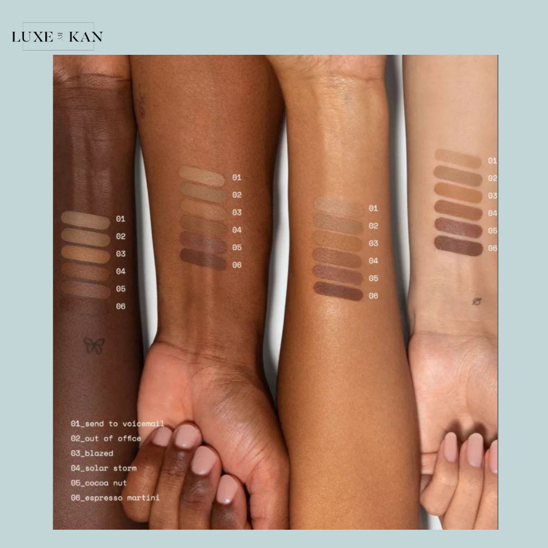 Three arms of different skin tones display six rows of makeup swatches, labeled with names and numbers for product identification.
