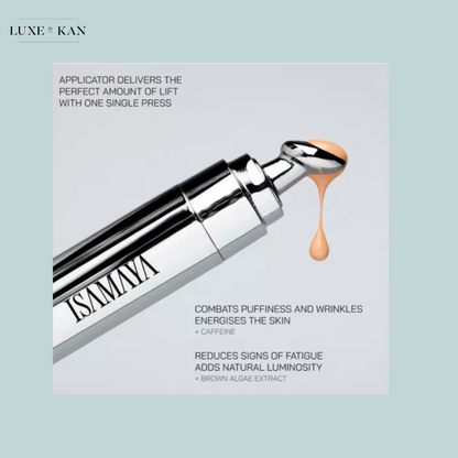 A sleek silver applicator delivers a peach-toned serum designed to reduce puffiness, wrinkles, and signs of fatigue, featuring caffeine and brown algae.