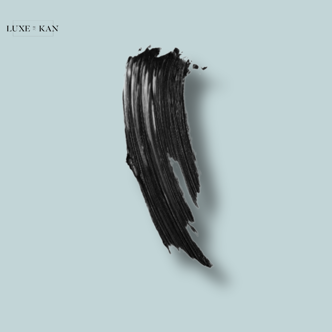 A bold black brushstroke against a soft blue background, showcasing the texture and richness of the product by Luxe & Kan.