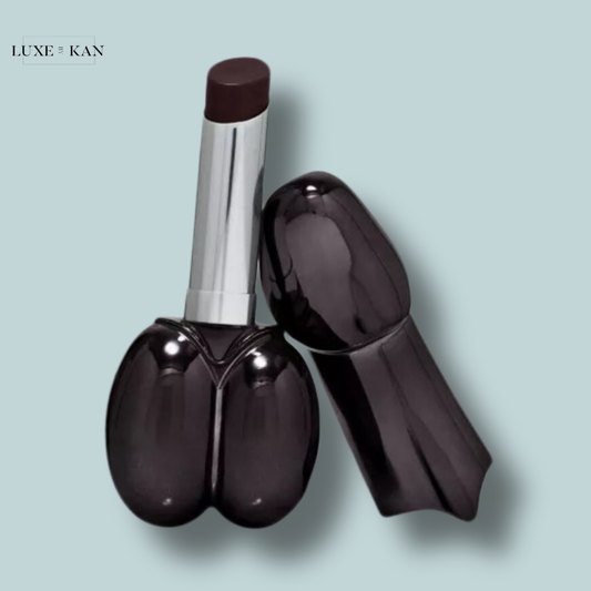 Pair of glossy black isamaya beauty water balm lipstick tubes, one capped and one open, revealing a deep burgundy lipstick bullet.