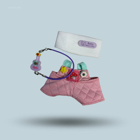 Labubu doll accessories set including pink quilted overalls, a white headband, and miniature guitar.