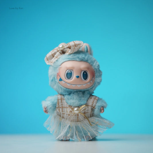 Labubu doll wearing a plaid academia fashion dress, matching bow with pearl, and a tulle skirt.