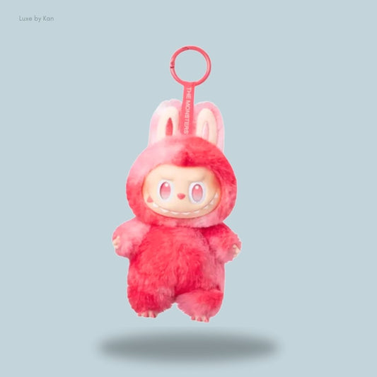 A Labubu plush keychain toy from The Monsters Big Into Energy Series – Love, featuring a cute monster in a pink bunny costume with a mischievous grin and oversized ears.