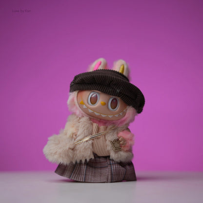 Labubu collectible doll outfitted in a five-piece autumn royale set with pink fur, a brown hat, and plaid skirt.