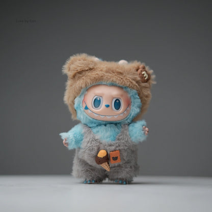 Labubu Fuzzy Treats two-piece collectible figure set featuring a light blue, gray, and tan fuzzy character with overalls and decorative food patches.