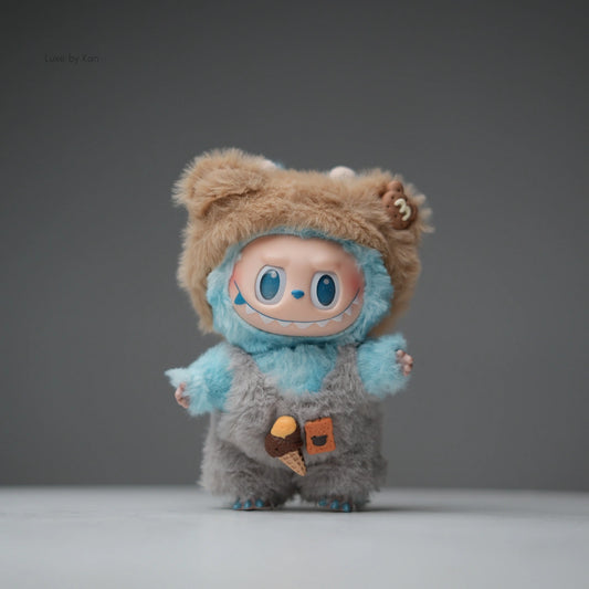 Labubu Fuzzy Treats two-piece collectible figure set featuring a light blue, gray, and tan fuzzy character with overalls and decorative food patches.