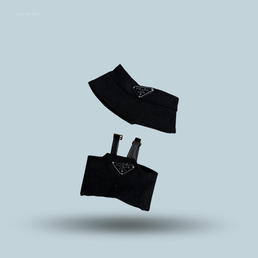 A two-piece black luxury streetwear set for Labubu, including a bucket hat and a top with adjustable straps, both featuring the Prada logo.