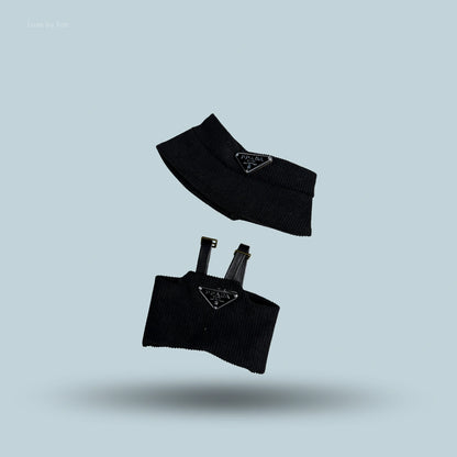 A two-piece black luxury streetwear set for Labubu, including a bucket hat and a top with adjustable straps, both featuring the Prada logo.