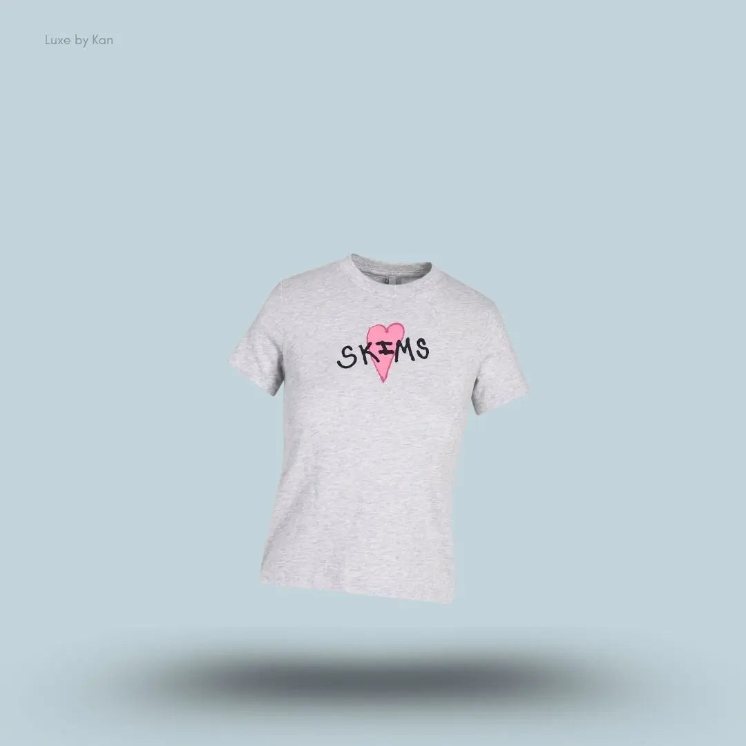 SKIMS Worn In Jersey T-Shirt in Light Heather Grey skims heart, flat lay on light blue background